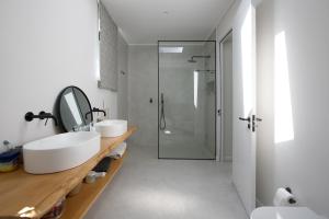 a white bathroom with two sinks and a shower at Table Mountain Constantiaberg view in Sweet Valley