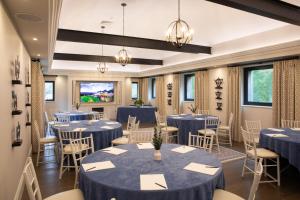a conference room with blue tables and chairs at Linthwaite House Hotel in Bowness-on-Windermere