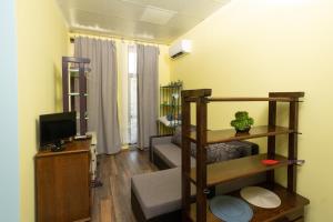 a living room with a couch and a television at Тракия 3А in Shumen