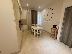 a kitchen with a table and a clock on the wall at Milano Central in Milan