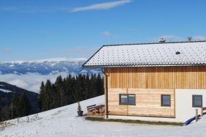 a building on top of a snow covered mountain at Chalet Langhans in Kamperkogel +18 photos