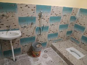 a bathroom with a sink and a shower and a toilet at Pindari Homestay in Bāgeshwar