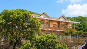 a house on a hill with trees in the foreground at Hwacheon Turkey Valley in Hwach'ŏn +10 photos