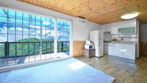 a kitchen with white appliances and a large window at Hwacheon Turkey Valley in Hwach'ŏn