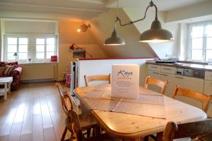 a kitchen with a wooden table with a sign on it at Midlum- Peppin, OG in Midlum