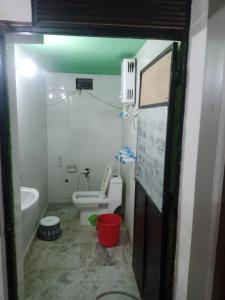 a small bathroom with a toilet and a sink at OP krishna homestay in Mathura