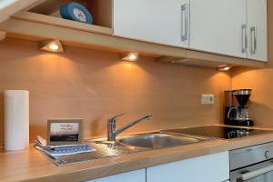 a kitchen with a sink and a counter top at MS Störtebecker, Sandwall in Wyk auf Föhr