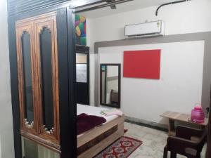 a room with a bed and a dresser and a mirror at OP krishna homestay in Mathura