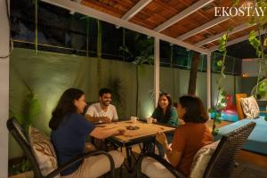a group of people sitting around a table at EKOSTAY - Assa Villa in Marna