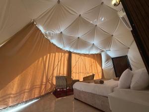 a bedroom with a bed in a tent at Hasan Zawaideh Camp in Wadi Rum