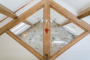 a wooden ceiling with a heart on it at Ty Coets in Llanfairpwllgwyngyll +50 photos