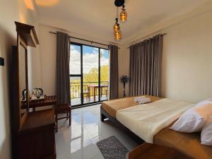 a bedroom with a bed and a large window at Climax View Point Inn in Bandarawela