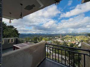 a balcony with a table and a view of a city at Climax View Point Inn in Bandarawela