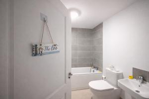 a white bathroom with a toilet and a sink at The Dene Homestay in Drogheda +21 photos