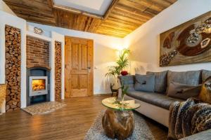 a living room with a couch and a fireplace at Göglgut in Lungötz