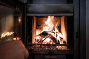 a person is looking inside of a fireplace at Göglgut in Lungötz