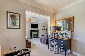 a living room with a desk and a fireplace at Willow Lodge, Wolfscastle in Haverfordwest