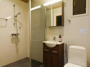 a bathroom with a toilet and a sink and a shower at TunturinTähti in Syöte +17 photos