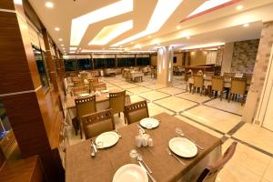 a dining room with a table and chairs and tables and chairsktop at Atlıhanpark Hotel in Batman