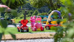 a group of toy cars sitting on the grass at Gapyeong Maplein Pension in Pocheon +2 photos