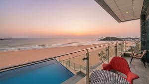 a balcony with a view of the beach at Goseong Moneblue Pension in Goseong