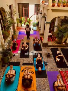 a group of people doing yoga in a courtyard at Hostel Cultural Pata y Perro in Tarija