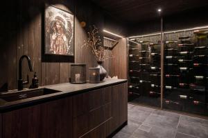 a kitchen with a sink and a wine cellar at FJELLRO Private Alpine Lodge Høgevarde in Flå