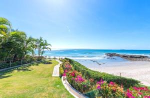 a path to the beach with flowers and palm trees at Villa Buho in Punta Mita in Punta Mita +51 photos