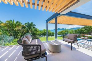 a patio with a couch and chairs on a deck at Villa Brisa in Punta Mita in Punta Mita +56 photos
