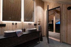 two sinks in a bathroom with wooden walls at FJELLRO Private Alpine Lodge Høgevarde in Flå +43 photos