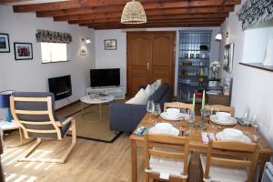 a living room with a table and a couch at La Bonne Vie Gite in Chaunay