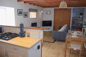 a kitchen and living room with a stove top oven at La Bonne Vie Gite in Chaunay +35 photos
