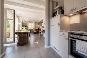 a kitchen with a table and a dining room at Ferienhaus Malve in Liepe