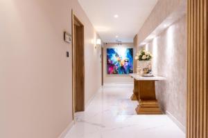 a hallway with a table and a painting on the wall at Berthas Collection By EM Hotels in Cartagena de Indias +20 photos