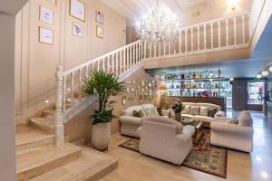 a living room with a staircase with chairs and a table at Berthas Collection By EM Hotels in Cartagena de Indias