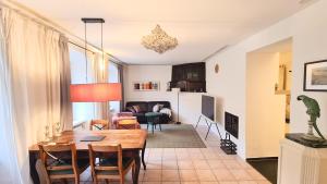a kitchen and living room with a table and chairs at Mosel-Side De Luxe Suite in Reil +10 photos
