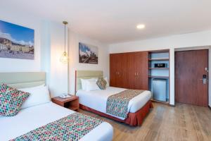 a hotel room with two beds and a kitchen at Hotel Andes Plaza in Bogotá +29 photos