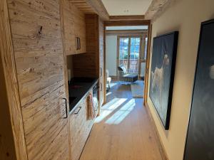 a room with a wooden wall with a wooden floor at Petite Fraise in Gstaad +5 photos