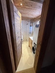 a kitchen with a washer and dryer in a house at Petite Fraise in Gstaad