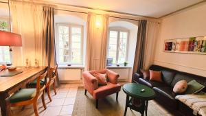 a living room with a couch and a table at Mosel-Side De Luxe Suite in Reil
