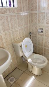 a bathroom with a toilet and a sink at Manja Homes in Ruiru