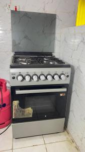 a stove in a kitchen next to a wall at Manja Homes in Ruiru