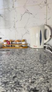 a white toaster sitting on a counter with some food at Manja Homes in Ruiru +5 photos