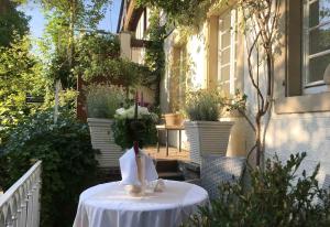 a table with a vase of flowers on it at Mosel-Side De Luxe Suite in Reil