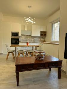 a kitchen with a table with a bowl on top of it at A casa di Ada in Finale Ligure +6 photos