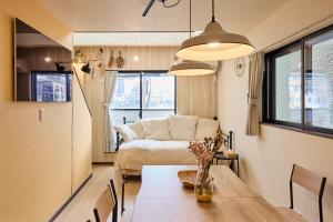 a living room with a table and a couch at 宿 花甜 in Osaka