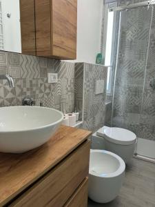 a bathroom with a sink and a toilet at A casa di Ada in Finale Ligure