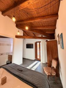 a bedroom with a bed and a chair at MECE Rooms in LʼAquila