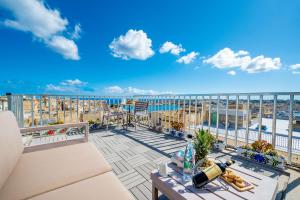 a balcony with a view of the ocean at Valletta Apartments 19 in Valletta