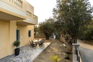 a patio with a table and chairs next to a building at Lindos Luxury Retro Villas in Lindos